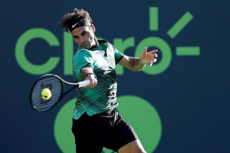 Mar 28, 2017; Miami, FL, USA; Roger Federer of Switzerland hits a forehand against Roberto Bautista Agut of Spain (not pictured) on day eight of the 2017 Miami Open at Crandon Park Tennis Center. Mandatory Credit: Geoff Burke-USA TODAY Sports