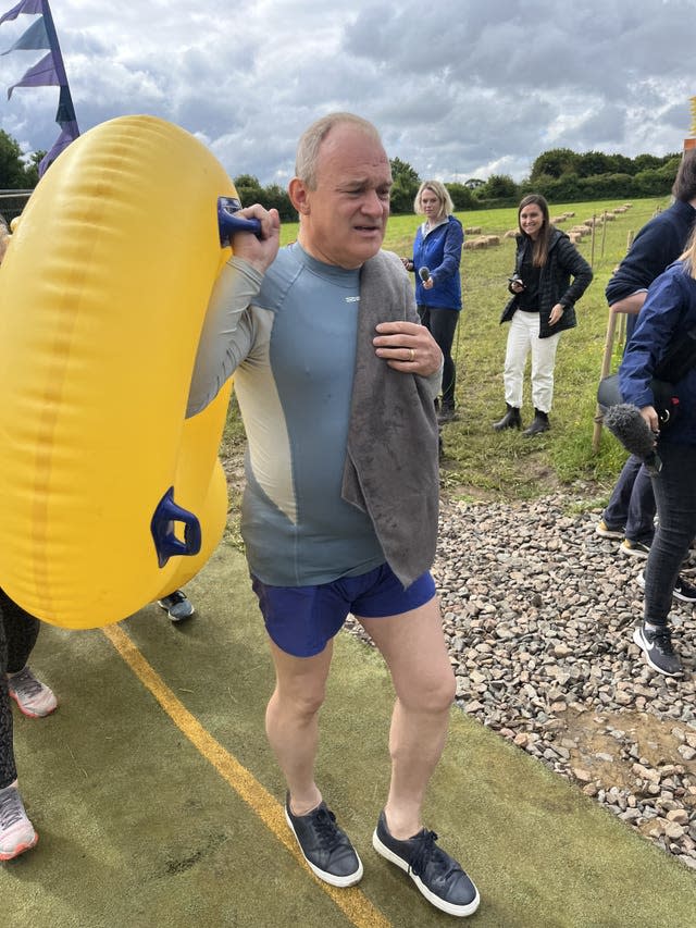 Sir Ed Davey carries a yellow rubber ring