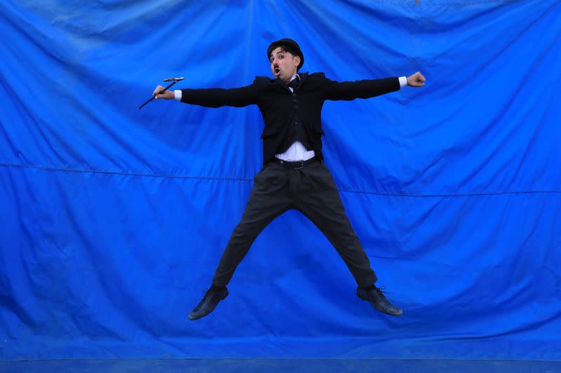 Usman Khan, 29, dressed up as Charlie Chaplin, poses for a photo as he performs in Peshawar