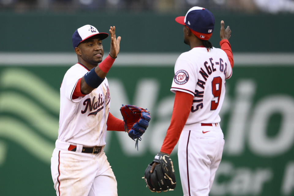 Washington Nationals' Victor Robles, left, and Dee Strange-Gordon (9) celebrate after the team's 1-0 win over the Los Angeles Dodgers in a baseball game Wednesday, May 25, 2022, in Washington. (AP Photo/Nick Wass)