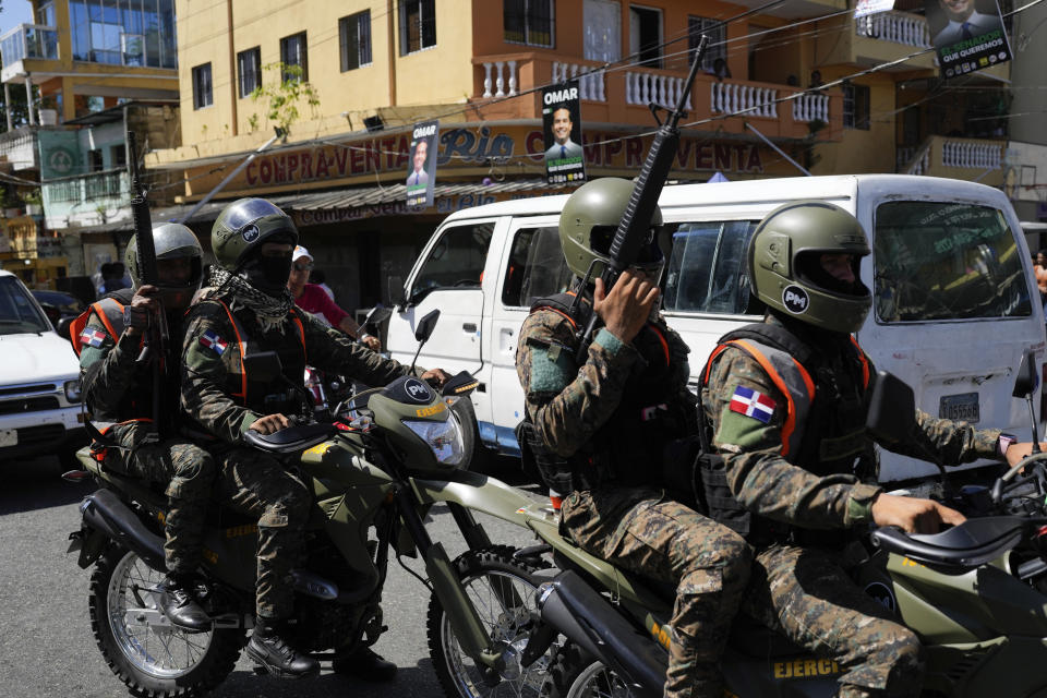 Military police patrol a polling station during general elections in Santo Domingo, Dominican Republic, Sunday, May 19, 2024. (AP Photo/Matias Delacroix)