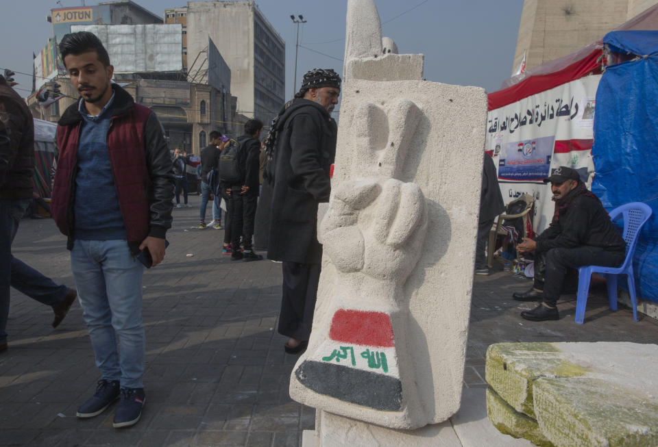 In this Sunday, Dec. 15, 2019, photo, a completed sculpture waits to be stored in preparation for an upcoming art exhibition, during the ongoing protests in Tahrir square, Baghdad, Iraq. Tahrir Square has emerged as a focus of the protests, with protesters camped out in dozens of tents. Dozens of people took part in the simple opening of the sculpture exhibition. (AP Photo/Nasser Nasser)