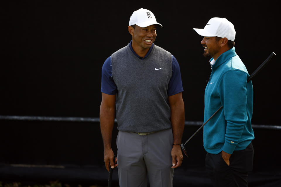 PACIFIC PALISADES, CALIFORNIA - FEBRUARY 14:  Tiger Woods of the United States and Jason Day of Australia talk while practicing on the putting green prior to The Genesis Invitational at Riviera Country Club on February 14, 2023 in Pacific Palisades, California. (Photo by Ronald Martinez/Getty Images)