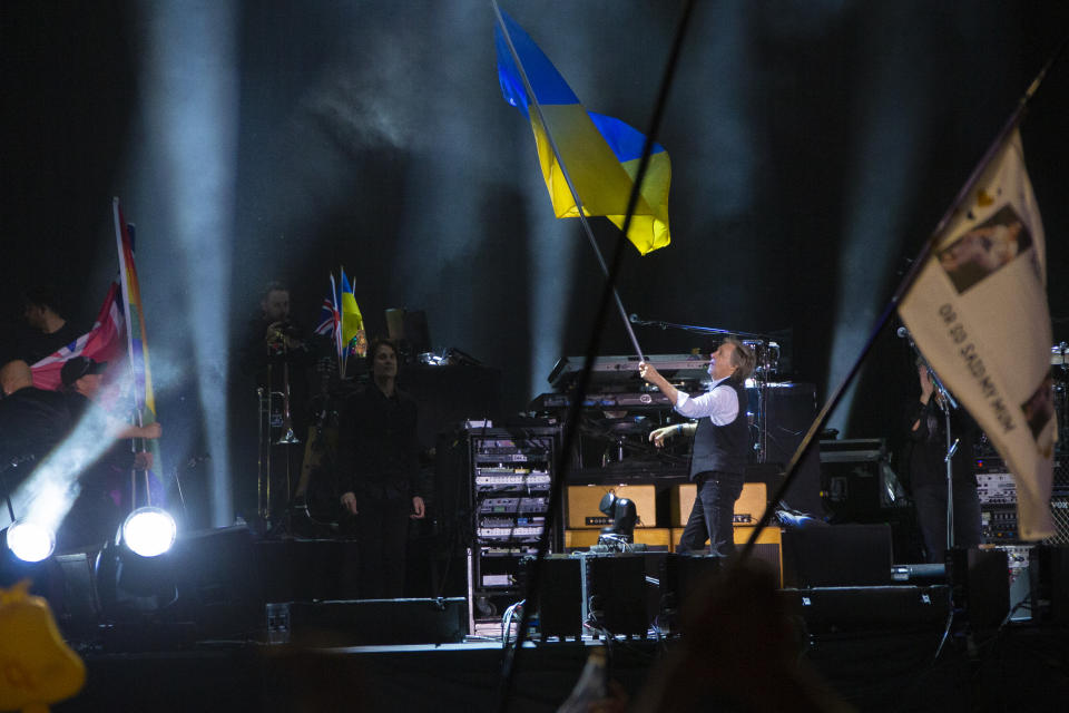 Paul McCartney waves the Ukrainian flag while performing on the Pyramid stage at Glastonbury Festival in Worthy Farm, Somerset, England, Saturday, June 25, 2022. (Photo by Joel C Ryan/Invision/AP)