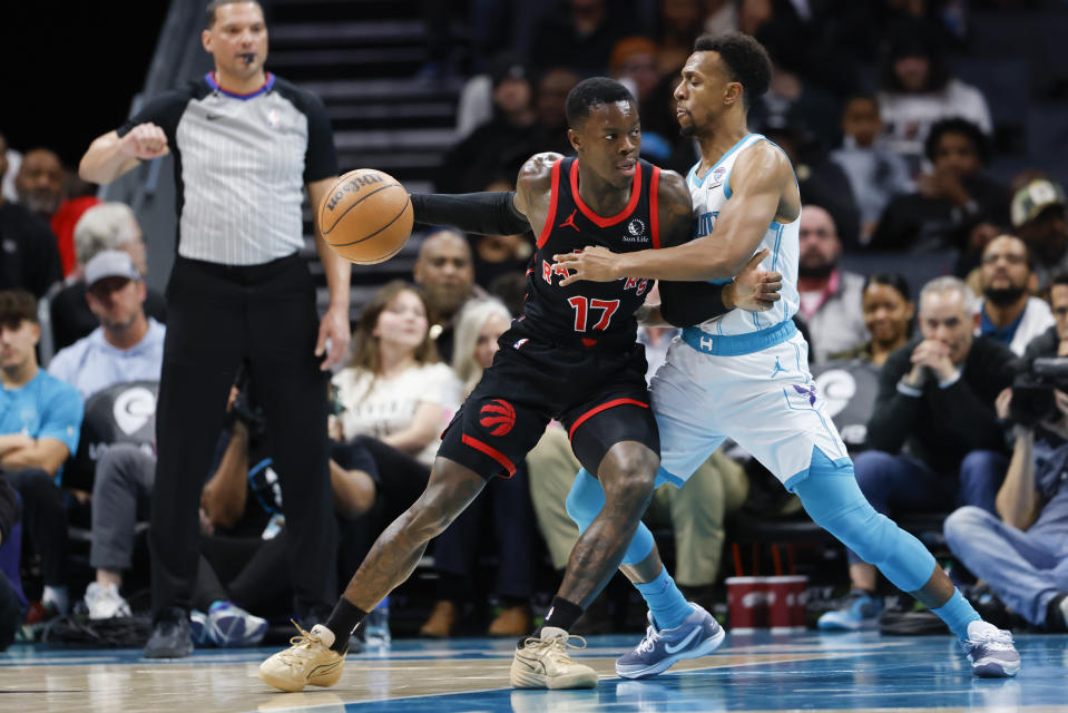 Toronto Raptors guard Dennis Schroder, left, drives into Charlotte Hornets guard Ish Smith during the second half of an NBA basketball game in Charlotte, N.C., Wednesday, Feb. 7, 2024. (AP Photo/Nell Redmond)