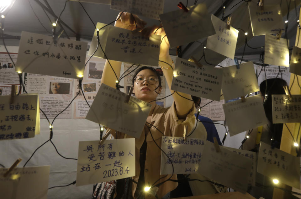 People leave messages during a candlelight vigil at Democracy Square in Taipei, Taiwan, Sunday, June 4, 2023, to mark the 34th anniversary of the Chinese military crackdown on the pro-democracy movement in Beijing's Tiananmen Square. (AP Photo/Chiang Ying-ying)