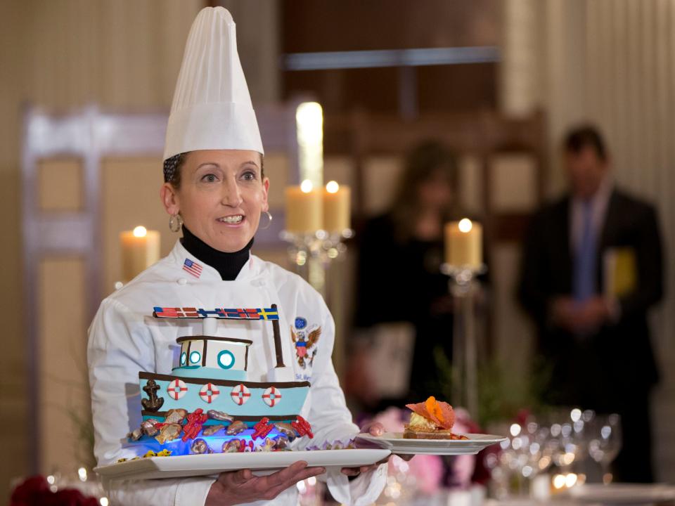 White House executive pastry chef Susan Morrison holds plates of desserts