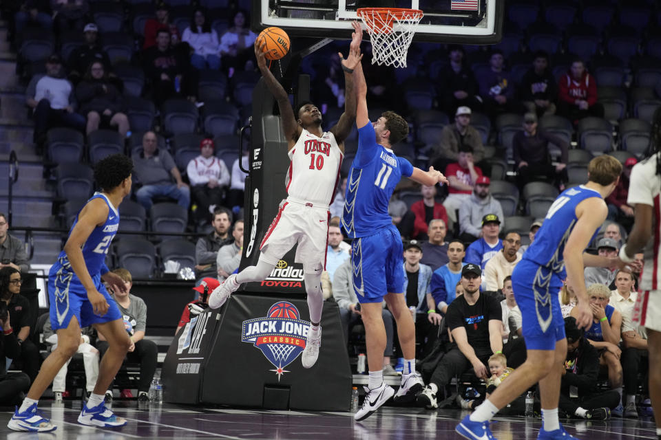 UNLV forward Kalib Boone (10) shoots over Creighton center Ryan Kalkbrenner (11) during the first half of an NCAA college basketball game Wednesday, Dec. 13, 2023, in Henderson, Nev. (AP Photo/John Locher)