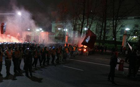 Riot police form a cordon in front of the Russian embassy during the annual far-right march, which coincides with Poland's national Independence Day in Warsaw November 11, 2013. REUTERS/Kacper Pempel