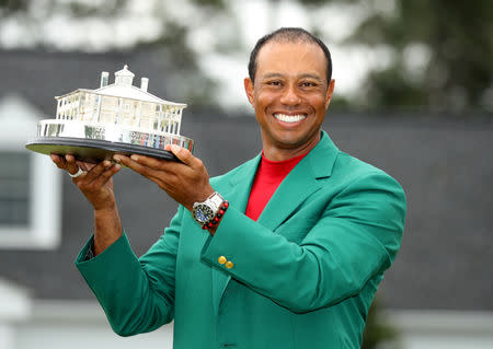 Golf - Masters - Augusta National Golf Club - Augusta, Georgia, U.S. - April 14, 2019. Tiger Woods of the U.S. celebrates with with his green jacket and trophy after winning the 2019 Masters. REUTERS/Lucy Nicholson