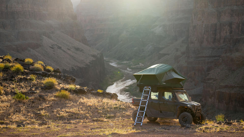 The 2024 Polaris Xpedition with camping accessories deployed in the backcountry.