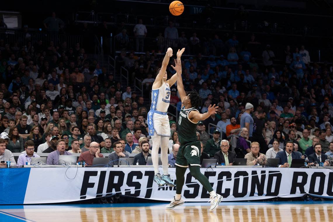 North Carolina’s Cormac Ryan (3) launches a three-point attempt against Michigan State’s during the first half on Saturday, March 23, 2024, during the second round of the NCAA Tournament at Spectrum Center in Charlotte, N.C.