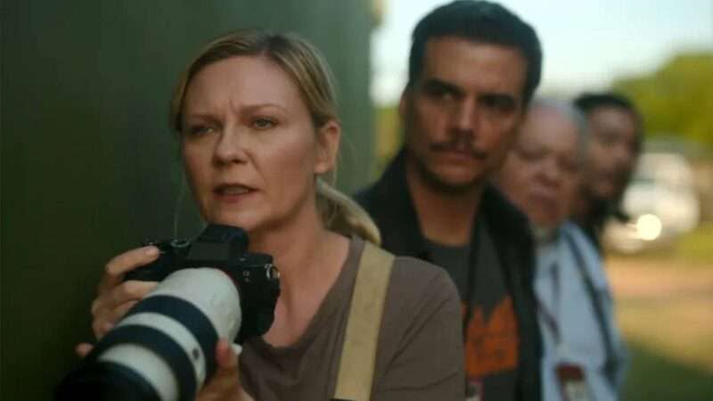 A still from the movie "Civil War" of Kirsten Dunst holding a camera