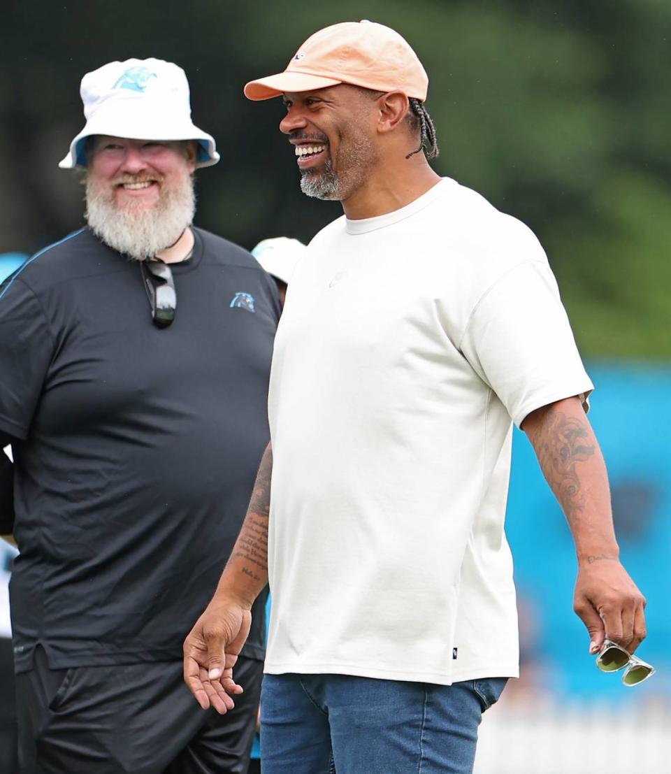 Former Carolina Panthers defensive end and NFL Hall of Fame member Julius Peppers speaks with personnel along the sideline as he watches the team practice on Tuesday, August 6, 2024.