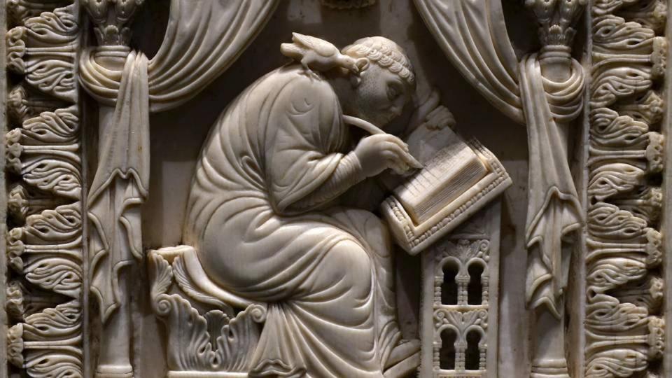 <span class="caption">Ivory carving of St. Gregory writing about the life of St. Benedict of Nurcia, 11th century.</span> <span class="attribution"><a class="link " href="https://saltandlighttv.org/blog/wp-content/uploads/2019/08/Kunsthistorisches_Museum_10th_century_ivory_Gregory_the_Great_23062013-cropped2.jpg" rel="nofollow noopener" target="_blank" data-ylk="slk:Kunsthistorisches Museum via Wikimedia Commons;elm:context_link;itc:0;sec:content-canvas">Kunsthistorisches Museum via Wikimedia Commons</a></span>