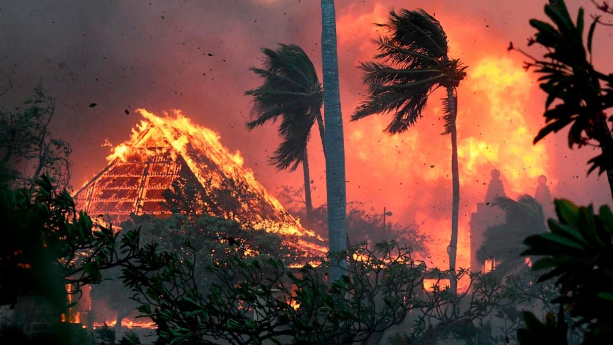 PHOTO: The hall of historic Waiola Church in Lahaina and nearby Lahaina Hongwanji Mission are engulfed in flames along Wainee Street on Aug. 8, 2023, in Lahaina, Hawaii. (Matthew Thayer/The Maui News via AP)