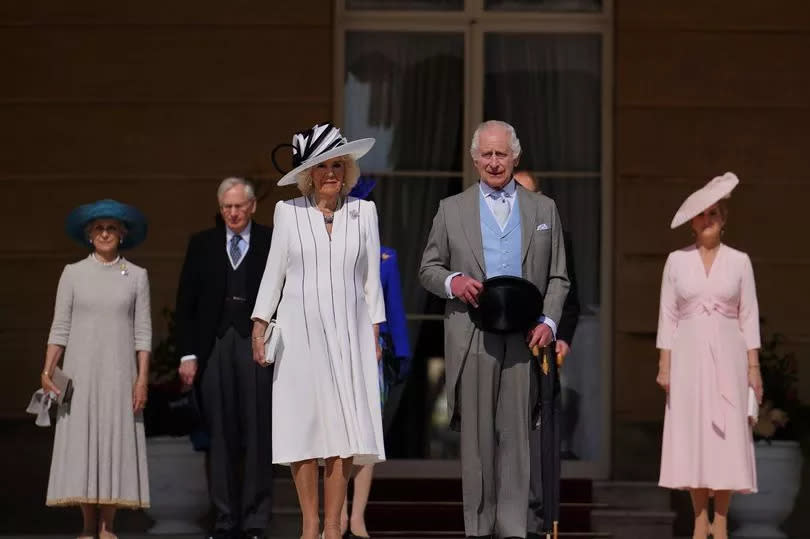King Charles III and Queen Camilla during a Royal Garden Party at Buckingham Palace today