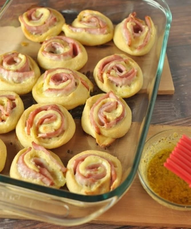 <p>These warm and comforting pinwheel keto roll ups are made from fathead dough and filled with ham and cheese.</p><p><strong>Get the recipe: <a href="https://peaceloveandlowcarb.com/hot-ham-and-cheese-roll-ups-with-dijon-butter-glaze-low-carb-gluten-free/" rel="nofollow noopener" target="_blank" data-ylk="slk:Hot Ham and Cheese Roll-Ups with Dijon Butter Glaze;elm:context_link;itc:0;sec:content-canvas" class="link ">Hot Ham and Cheese Roll-Ups with Dijon Butter Glaze </a></strong></p>