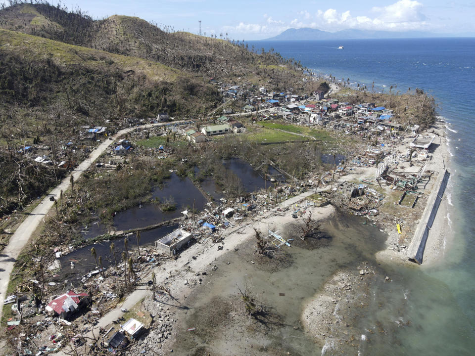 In this photo provided by Greenpeace, damaged homes due to Typhoon Rai lie along a coastal village in Surigao City, southern Philippines Monday Dec. 20, 2021. The governor of a central Philippine province devastated by Typhoon Rai last week pleaded on radio Tuesday for the government to quickly send food and other aid, warning that without outside help, army troops and police forces would have to be deployed to prevent looting amid growing hunger. (Erwin Mascarinas/Greenpeace via AP)