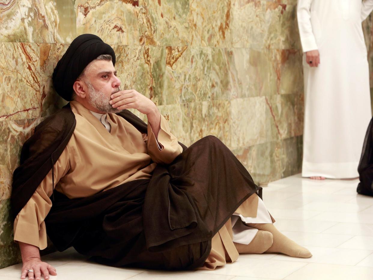 Iraqi Shia cleric Muqtada al-Sadr visits his father's grave after parliamentary election results were announced, in Najaf: Reuters