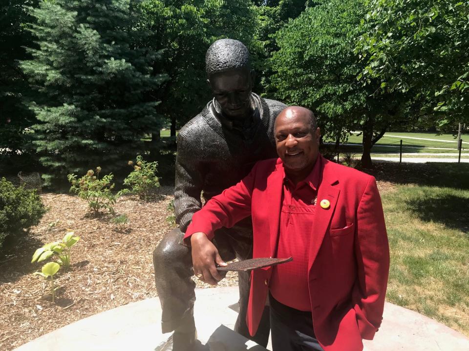 Jeff Johnson, President of Iowa State's Alumni Association, stands next to the Jack Trice statue on Iowa State's central campus.