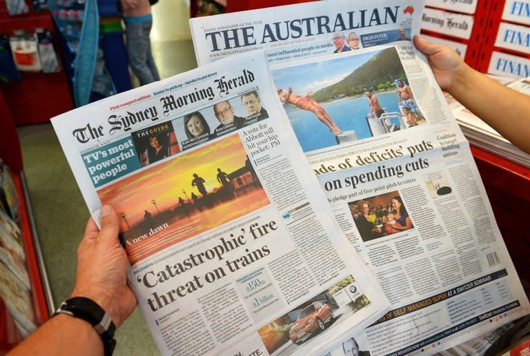 The new tabloid-sized version of The Sydney Morning Herald (L) is pictured beside The Australian broadsheet paper in Sydney on March 4, 2013. Herald editor-in-chief Sean Aylmer said the move to a "compact" format on the weekday editions was in response to reader wishes