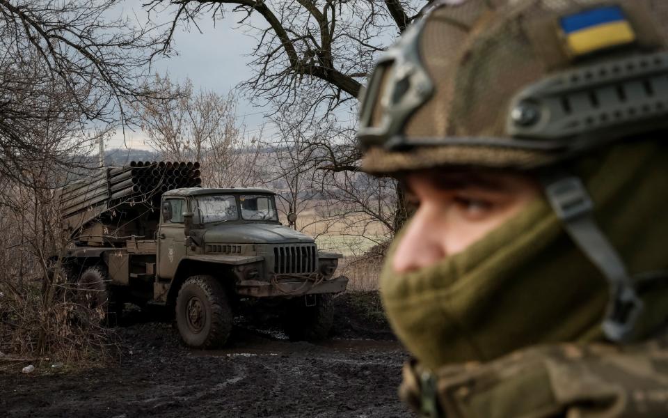 A Ukrainian serviceman of the 59th Separate Motorised Infantry Brigade of the Armed Forces of Ukraine looks on next to a BM-21 Grad multiple launch rocket system near a frontline