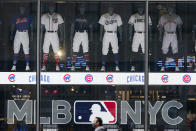 Pedestrians pass the MLB Flagship store Wednesday, Sept. 30, 2020, in New York. Major League Baseball’s first retail store opens Friday. (AP Photo/Frank Franklin II)