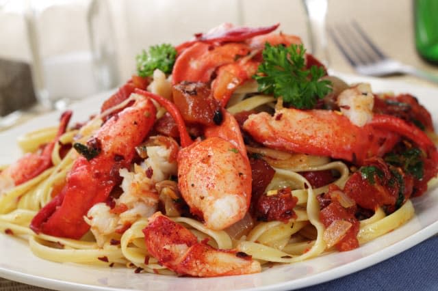 A plate of fettuccine pasta with Lobster and Fire roasted tomatoes in a spicy red pepper flake sauce