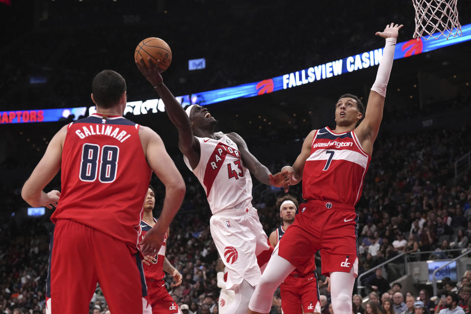 Toronto Raptors' Pascal Siakam (43) shoots against Washington Wizards' Patrick Baldwin Jr. (7) as Wizards' Danilo Gallinari (88) looks on during second-half preseason NBA basketball game action in Toronto, Friday Oct. 20, 2023. (Chris Young/The Canadian Press via AP)