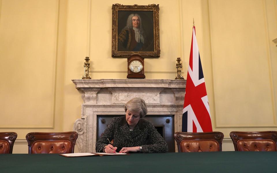 Theresa May in the cabinet signing the Article 50 letter, preparing to trigger the start of the UK's formal withdrawal from the EU - Christopher Furlong /PA