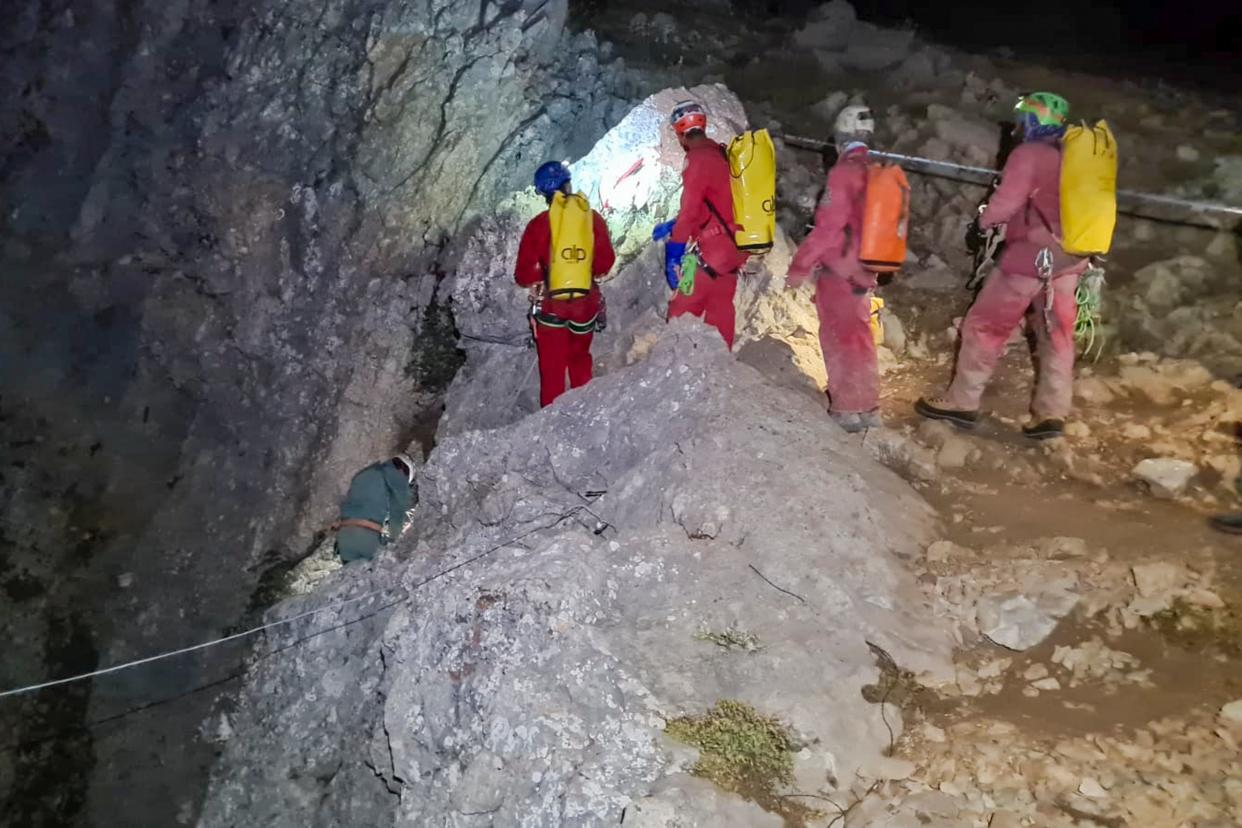 Members of the CNSAS, Italian alpine and speleological rescuers, start to descent on ropes the Morca cave during a rescue operation near Anamur, south Turkey, Monday, Sept. 11, 2023 (AP)