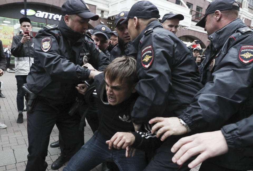 Police detain an activist during a protest in the center of Moscow, Russia, Saturday, Aug. 17, 2019. People rallied Saturday against the exclusion of some city council candidates from Moscow's upcoming election. (AP Photo)