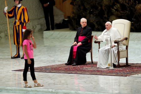 Pope Francis allows a little girl suffering from an undisclosed illness to move around undisturbed clapping and dancing on the stage for most of his general audience in Paul VI Hall at the Vatican