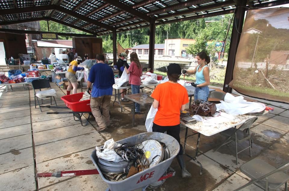 Volunteers go through stuff being brought out of the Appalshop, a cultural media arts center in Whitesburg, it was flooded Wednesday in Eastern, Ky.July 29, 2022