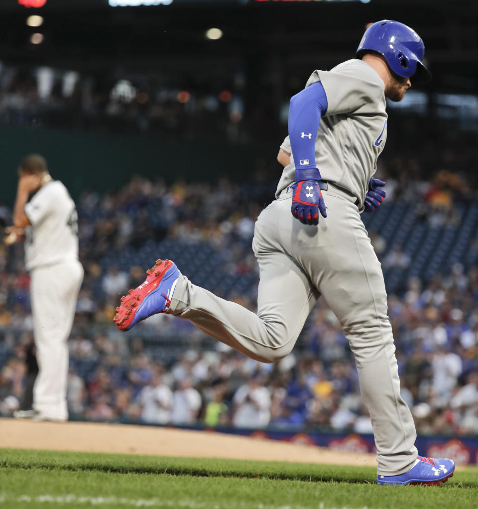 Chicago Cubs' Ian Happ rounds the bases after hitting a solo home run off Pittsburgh Pirates starting pitcher Ivan Nova, left, during the fourth inning of a baseball game Thursday, Aug. 16, 2018, in Pittsburgh. (AP Photo/Keith Srakocic)