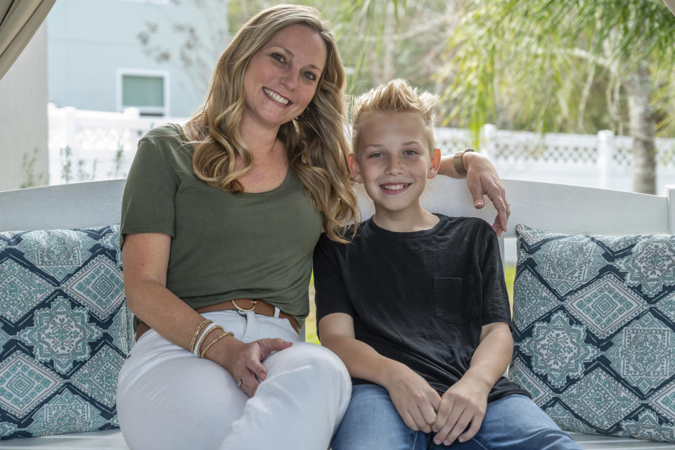 Holly Nover sits with her son, Colton Nover, 10, on a backyard swing at their home Wednesday, Feb. 16, 2022, in St. Johns, Fla. Holly, a speech pathologist active in the National Stuttering Association, said many people will surely be interested in trying stuttering medications – although not her. She is happy with her life as it is and has accepted her stuttering, she said. If her son were struggling and wanted to try medication as a teen, however, she’d be open to the idea. (AP Photo/Fran Ruchalski)