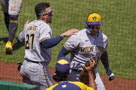 Milwaukee Brewers' Omar Narvaez, right, celebrates with Willy Adames (27) as he returns to the dugout after hitting a two-run home run off Pittsburgh Pirates starting pitcher Zach Thompson during the fifth inning of a baseball game in Pittsburgh, Sunday, July 3, 2022. (AP Photo/Gene J. Puskar)