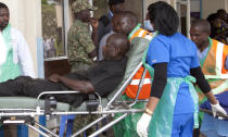 An injured person with gun wounds is brought to the Kenyatta National Hospital in Nairobi, Kenya, Tuesday, Jan. 15, 2019. Terrorists attacked an upscale hotel complex in Kenya's capital Tuesday, sending people fleeing in panic as explosions and heavy gunfire reverberated through the neighborhood. (AP Photo/Sayyid Abdul Azim)