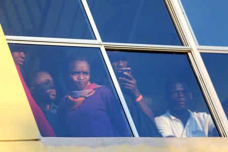 Haitian migrants look from behind a window inside Padre Chava shelter after leaving Brazil, where they south refuge after Haiti's 2010 earthquake, but are now attempting to enter the U.S., in Tijuana, Mexico, October 3, 2016. REUTERS/Edgard Garrido