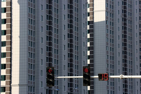 Traffic lights are seen in front of residential buildings in Huaian, Jiangsu province, China October 6, 2018. Picture taken October 6, 2018. REUTERS/Stringer