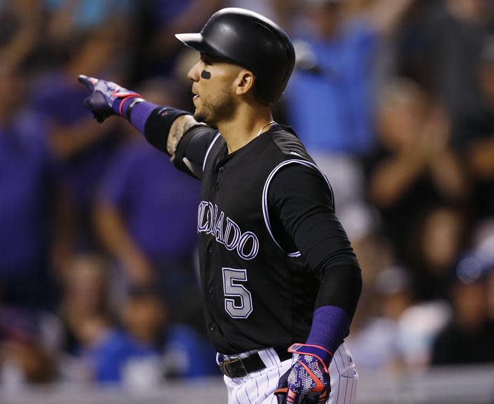 Carlos Gonzalez celebrates his two-run home run in Wednesday's 12-2 win against the Dodgers. (AP)