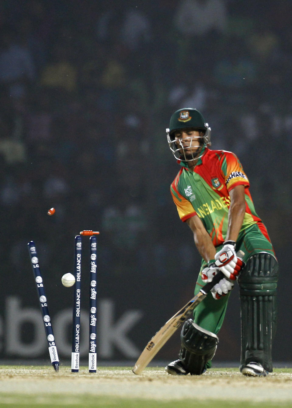 The bails fly off the wickets to dismiss Bangladeshi cricketer Nasir Hossain during a warm-up cricket match against United Arab Emirates ahead of the Twenty20 World Cup Cricket in Fatullah, near Dhaka, Bangladesh, Wednesday, March 12, 2014. (AP Photo/A.M. Ahad)