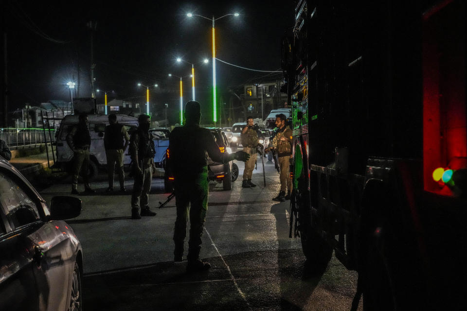 Indian policemen guard as they stop civilians on a road for checking ahead of G20 tourism working group meeting in Srinagar, Indian controlled Kashmir, Monday, May 15, 2023. Indian authorities have stepped up security and deployed elite commandos to prevent rebel attacks during the meeting of officials from the Group of 20 industrialized and developing nations in the disputed region next week. (AP Photo/Mukhtar Khan)