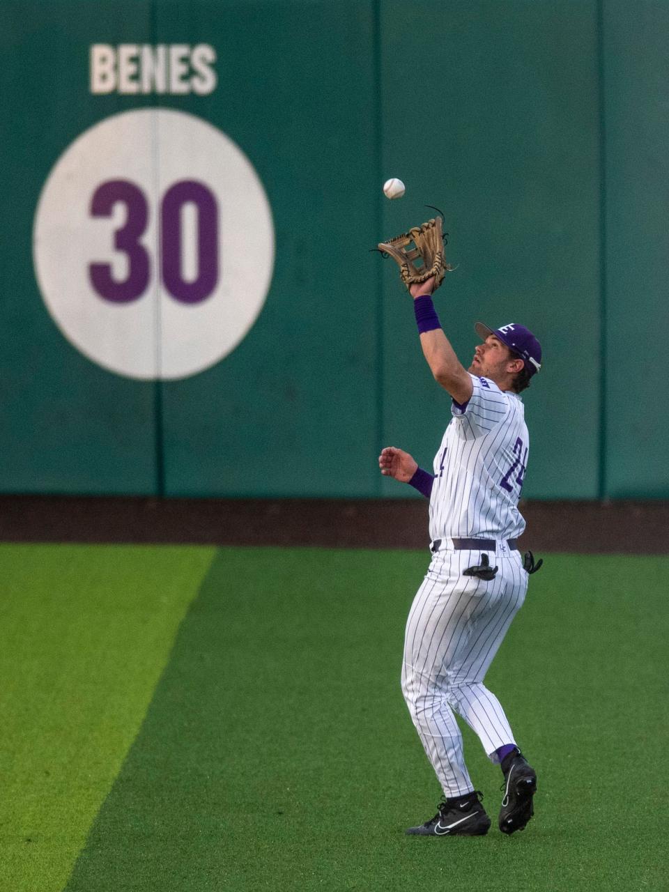 Evansville’s Eric Roberts (24) catches the ball in the outfield aas the University of Evansville Purple Aces play the Valparaiso University Beacons at Charles H. Braun Stadium in Evansville, Ind., Friday evening, April 7, 2023.