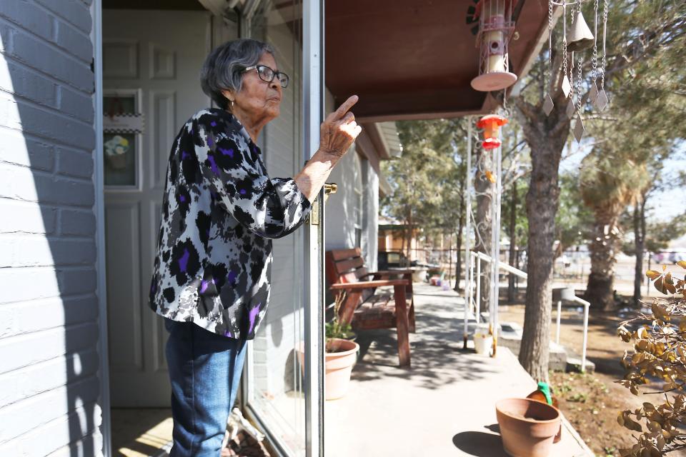 Maria Baeza Valeriano stands on her front porch talking about her neighborhood on April 9, 2021, in Pecos, Texas. Maria lives right across the street from what used to be a housing area for oil field workers. It is now being used as a migrant shelter for unaccompanied minors.