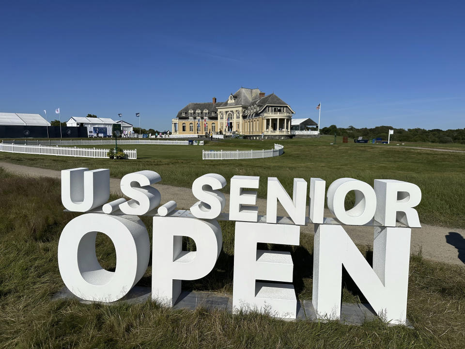 The clubhouse at the Newport Country Club is visible Friday, June 28, 2024, behind a sign for the U.S. Senior Open which is being played June 27-30 in Newport, R.I. (AP Photo/Jimmy Golen)