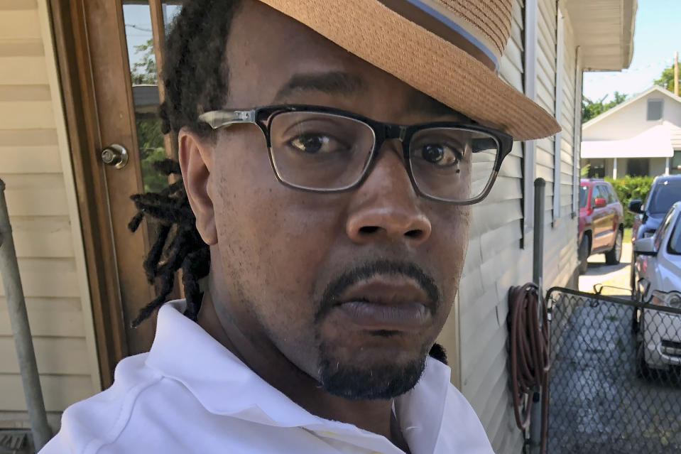 In this photo made on July 29, 2020, Dion Green stands outside his home in Dayton, Ohio. Green whose father died in a mass shooting on a night out together, spoke about the book he wrote about surviving that shooting as the anniversary of the 2019 shooting approaches. (AP Photo/Dan Sewell)