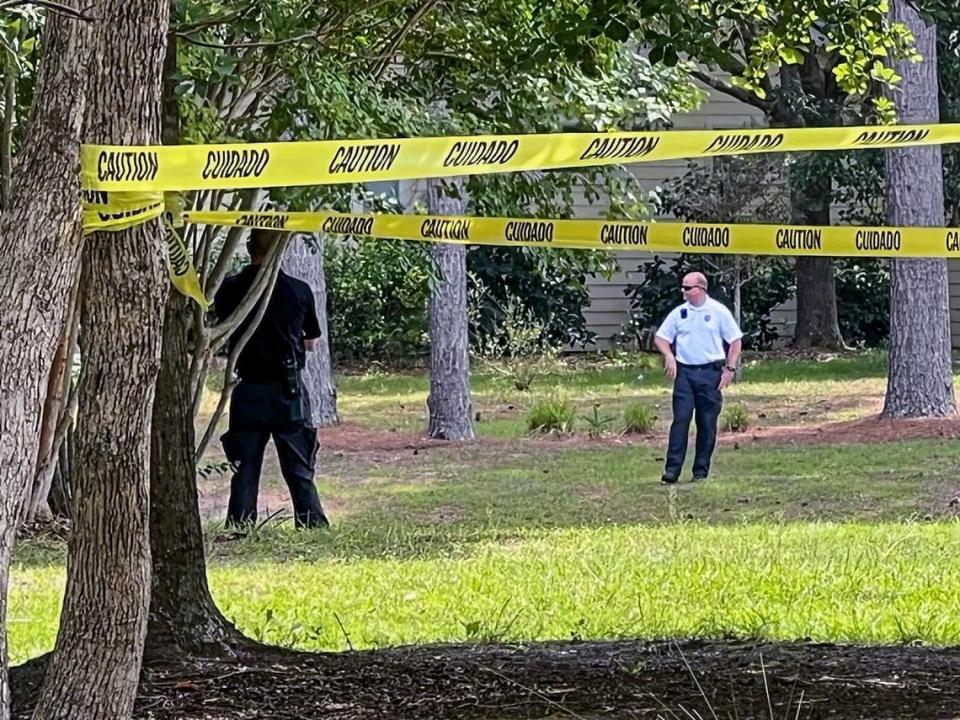 Caution tape surrounds an area near a Commodore Dupont Street lagoon after law enforcement responded to an alligator attack that killed a person on Monday, Aug. 15, 2022 in Sun City Hilton Head.