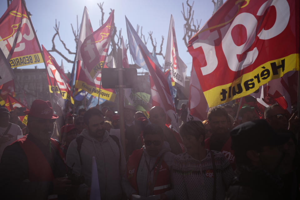 People demonstrate before French President Emmanuel Macron's visit, Thursday, April 20, 2023 in Ganges, southern France. The French leader tries to repair damage done to his presidency by forcing through unpopular pension reforms. Raising the retirement age from 62 to 64 has ignited a months-long firestorm of protest in France. (AP Photo/Daniel Cole)